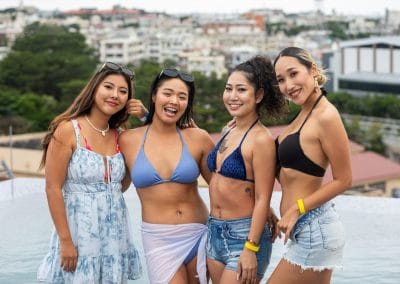 4 ladies posing in front of pool at Okinawa pool party