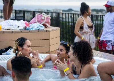 Three ladies in a jacuzzi at an Okinawa pool party